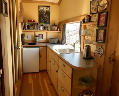 a small kitchen with a sink and a dishwasher at Blitz Beach House Oceanside Suite in Powell River