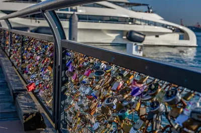 a bunch of locks on a fence next to a boat at Coast Lonsdale Quay Hotel in North Vancouver