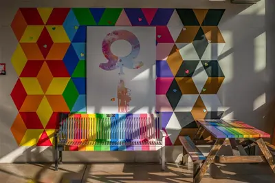a room with a colorful wall with a mural at Coast Lonsdale Quay Hotel in North Vancouver