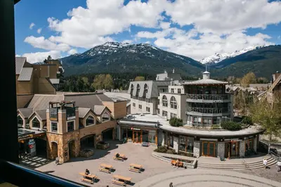 an aerial view of a building with mountains in the background at Carleton Lodge in Whistler