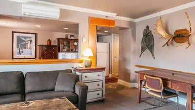 a living room with a couch and a table at Carleton Lodge in Whistler