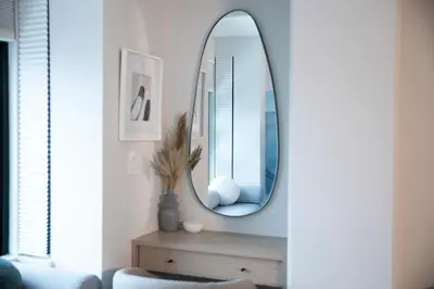 a mirror on a wall in a living room at Carleton Lodge in Whistler