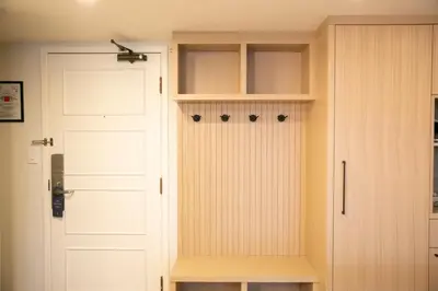 a closet with a white door and a white cabinet at Carleton Lodge in Whistler