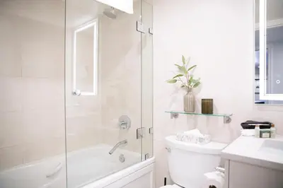 a bathroom with a shower and a toilet and a sink at Carleton Lodge in Whistler