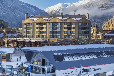 a ski resort with a large building in the snow at Carleton Lodge in Whistler