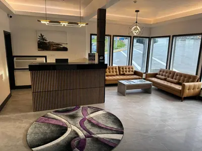 a living room with couches and a table at Waterways, A Boutique Hotel in Powell River