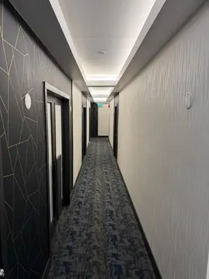 a corridor of an office building with a long hallway at Waterways, A Boutique Hotel in Powell River