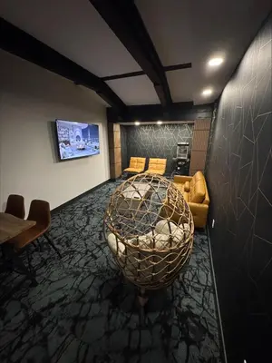 a room with a round table and a couch at Waterways, A Boutique Hotel in Powell River