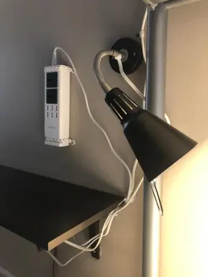 a light hanging from a wall with a socket at Banff International Hostel in Banff