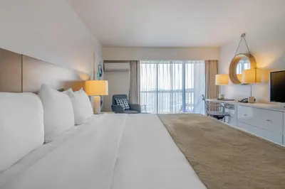 a large white bed in a hotel room at Bayside Resort, an Ascend Collection Resort in Parksville