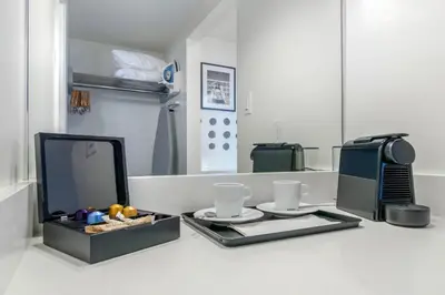 a table with a tray with two cups and a television at Bayside Resort, an Ascend Collection Resort in Parksville