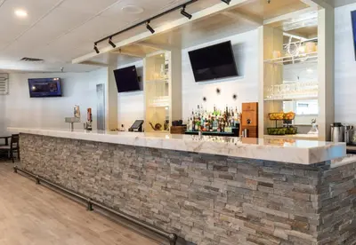 a bar in a restaurant with a brick wall at Bayside Resort, an Ascend Collection Resort in Parksville