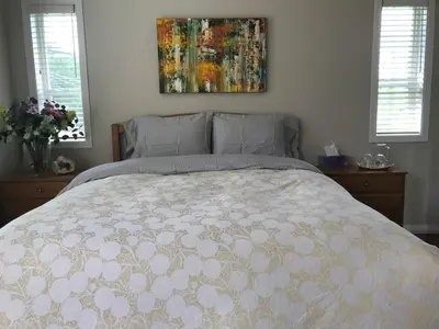 a bedroom with a bed and a painting on the wall at Royalty B&B in Richmond