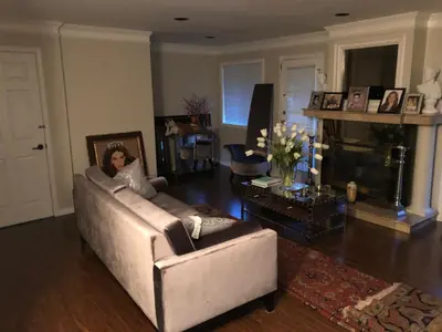 a woman sitting on a couch in a living room at Royalty B&B in Richmond