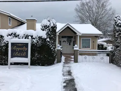 a house with a sign in the snow at Royalty B&B in Richmond