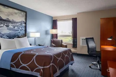 a hotel room with a bed and a desk and a chair at Super 8 by Wyndham Sherwood Park/Edmonton Area in Sherwood Park