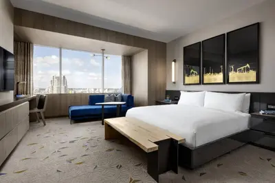 a hotel room with a bed and a living room at JW Marriott Edmonton ICE District in Edmonton