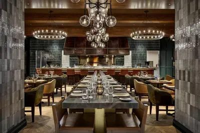 a dining room with a long table and chairs at JW Marriott Edmonton ICE District in Edmonton
