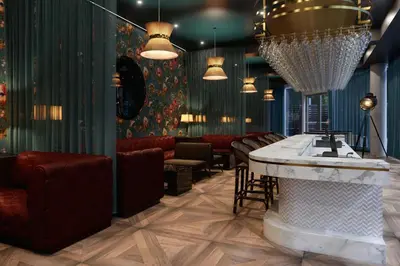 a restaurant with a bar with chairs and a table at JW Marriott Edmonton ICE District in Edmonton