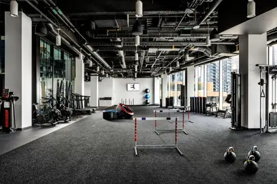 a gym with exercise equipment in a large room with windows at JW Marriott Edmonton ICE District in Edmonton