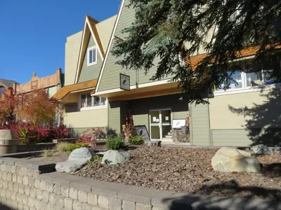 a house with a retaining wall in front of it at Kimberley Downtown Accommodation in Kimberley