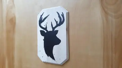 a sign with a picture of a deer on a wall at Kimberley Downtown Accommodation in Kimberley