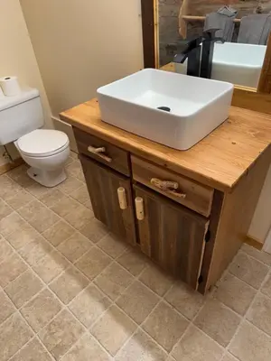 a bathroom with a white sink and a toilet at Nakiska Bear Ranch in Clearwater