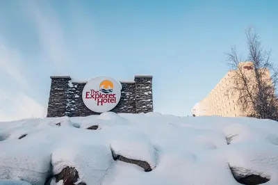 a sign on a building in the snow at The Explorer Hotel in Yellowknife