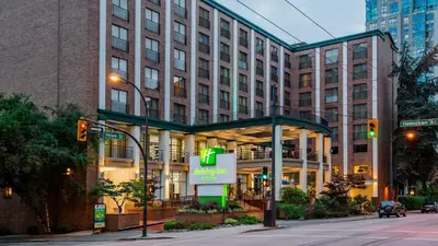 a large building with a sign in front of it at Holiday Inn & Suites Vancouver Downtown by IHG in Vancouver