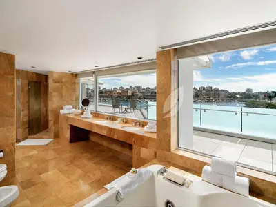 a bathroom with a tub and a large window at Inn at Laurel Point in Victoria