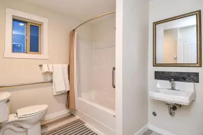 a bathroom with a toilet and a sink and a shower at Chateau Riverside in Campbell River