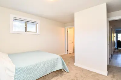 a bedroom with a bed and a window at Chateau Riverside in Campbell River