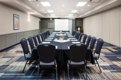 a conference room with a long table and chairs at Holiday Inn & Suites Grande Prairie by IHG in Grande Prairie