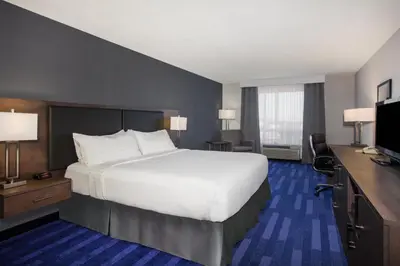 a hotel room with a large bed and a desk at Holiday Inn & Suites Grande Prairie by IHG in Grande Prairie