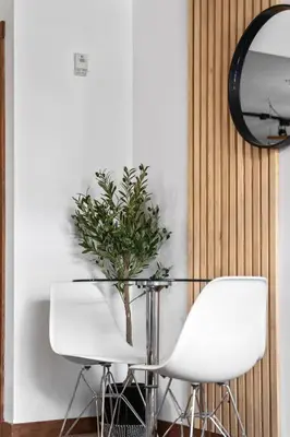 a dining room with a glass table and white chairs at ⭐️ Luxury Mountain View Studio in Canmore ⭐️ in Canmore