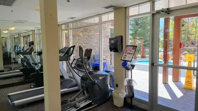a gym with treadmills and ellipticals in a building at ⭐️ Luxury Mountain View Studio in Canmore ⭐️ in Canmore