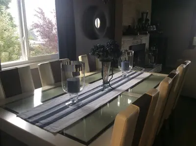a dining room table with glasses on top of it at Berkie’s Bed & Breakfast in Port Alberni