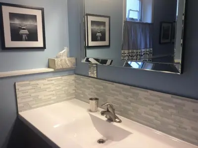 a bathroom with a sink and a mirror at Berkie’s Bed & Breakfast in Port Alberni