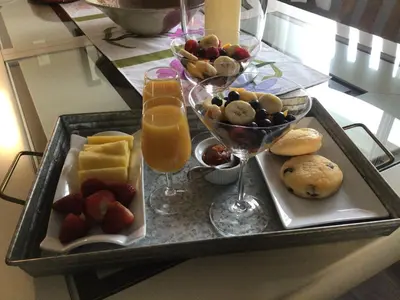 a tray of food with fruit and drinks on a table at Berkie’s Bed & Breakfast in Port Alberni
