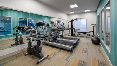 a gym with treadmills and elliptical machines at Holiday Inn Express Airdrie by IHG in Airdrie