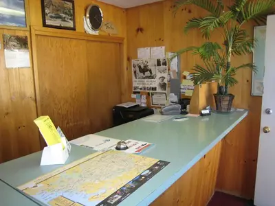 an office with a counter with a map on it at Gold Pan Motel in Quesnel