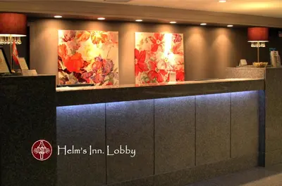 a lobby with three paintings of flowers on the wall at Helm's Inn in Victoria
