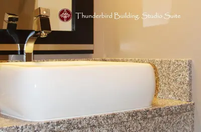 a bathroom sink with a faucet on a counter at Helm's Inn in Victoria