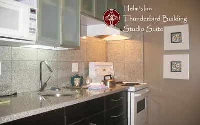 a kitchen with a sink and a counter top at Helm's Inn in Victoria