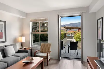 a living room with a couch and a table at Walnut Beach Resort in Osoyoos