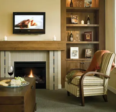 a living room with a fireplace and a tv at Walnut Beach Resort in Osoyoos