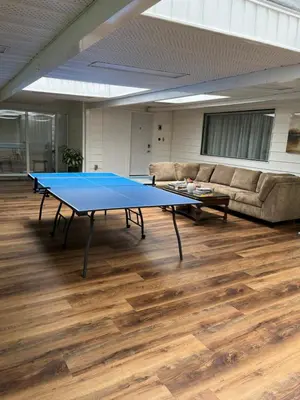 a ping pong table in a room with a couch at Vancouver shaughnessy guest home in Vancouver