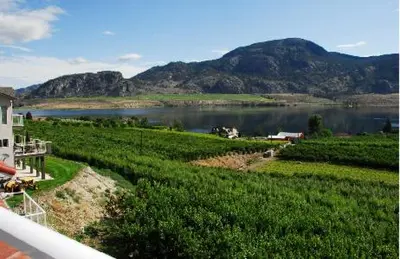 a view of a lake with mountains in the background at Ciliegia Villa in Osoyoos