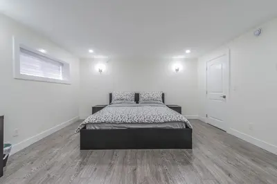 a bedroom with a bed in a white room at Private Vacation Guest Suite Near Beach in White Rock