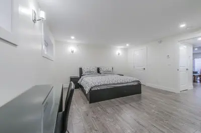 a bedroom with a bed in a white room at Private Vacation Guest Suite Near Beach in White Rock